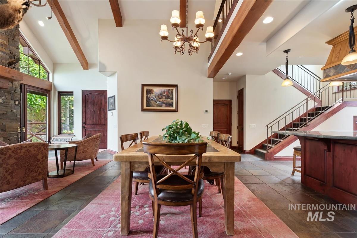 106 Hidden Hollow Road Hailey, ID 83333 - Photo 28 of 49 Vaulted ceilings with exposed wood beams, stone fireplace, and floor-to-ceiling windows
