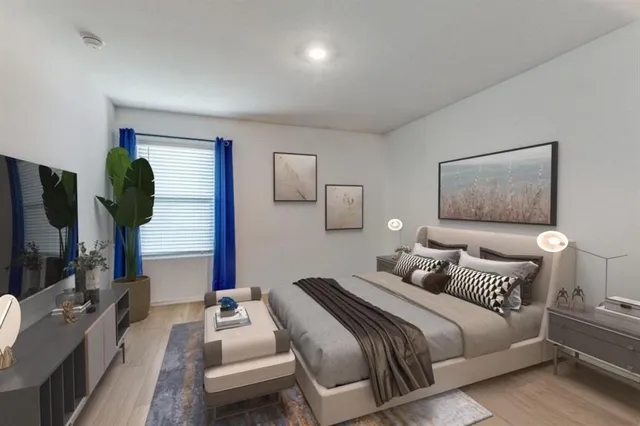 a bedroom with a bed a couch and dresser