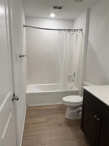 a bathroom with a shower a toilet and a sink