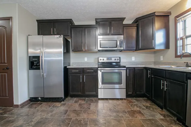 a kitchen with a stove sink and refrigerator