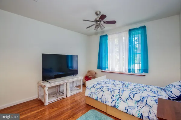a bedroom with bed and wooden floor