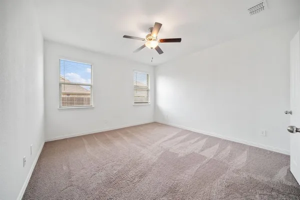 a view of a livingroom with a ceiling fan and window