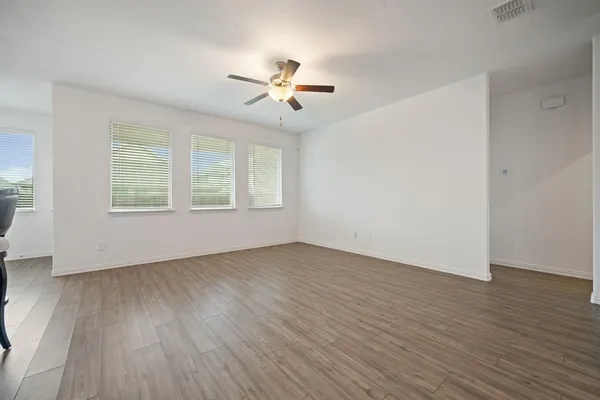 a kitchen with a sink cabinets and wooden floor