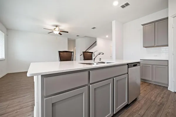 a kitchen with stainless steel appliances granite countertop a stove microwave and sink