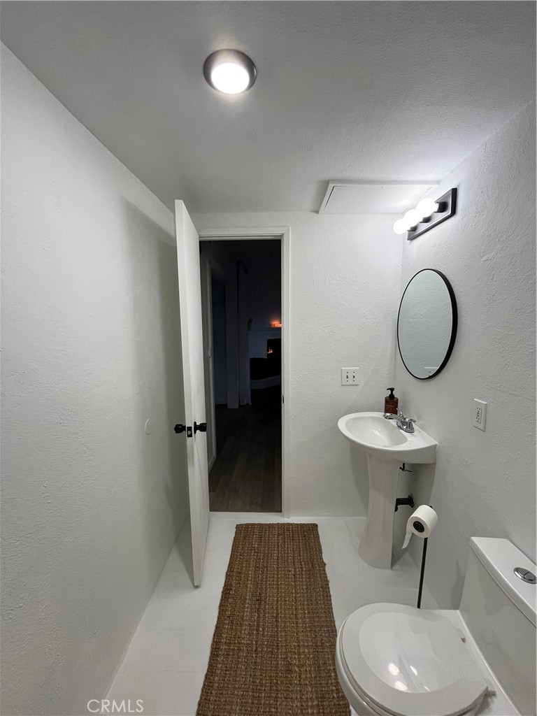 24875 Marion Ridge Drive Idyllwild, CA 92549 - Photo 26 of 47 a bathroom with a sink a toilet a mirror and shower