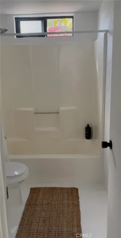 a bathroom with a shower and a toilet