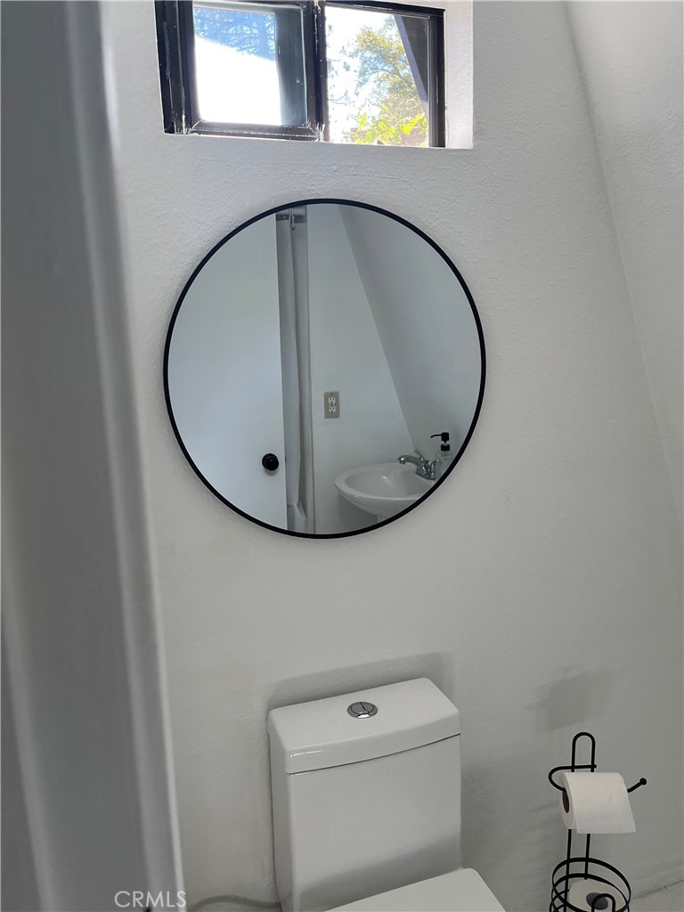 24875 Marion Ridge Drive Idyllwild, CA 92549 - Photo 30 of 47 a bathroom with a toilet a sink and mirror