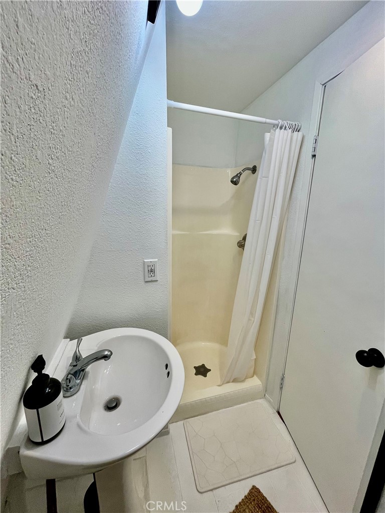 24875 Marion Ridge Drive Idyllwild, CA 92549 - Photo 31 of 47 a bathroom with a bathtub and shower