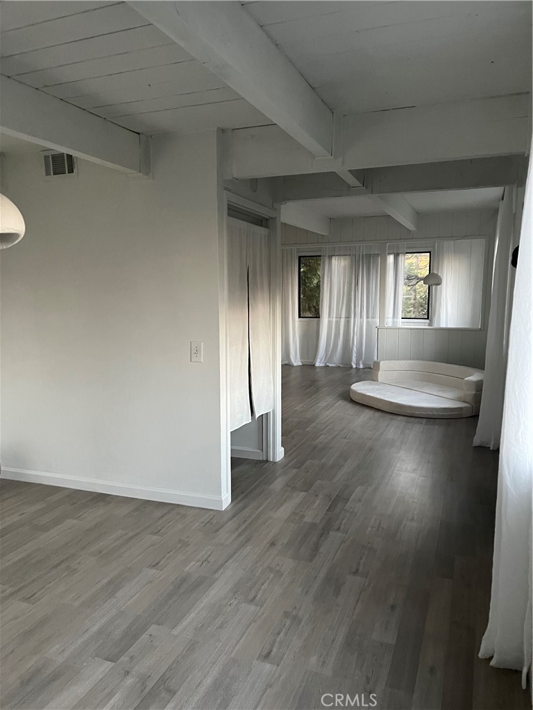 24875 Marion Ridge Drive Idyllwild, CA 92549 - Photo 33 of 47 a view of an empty room with wooden floor and a window
