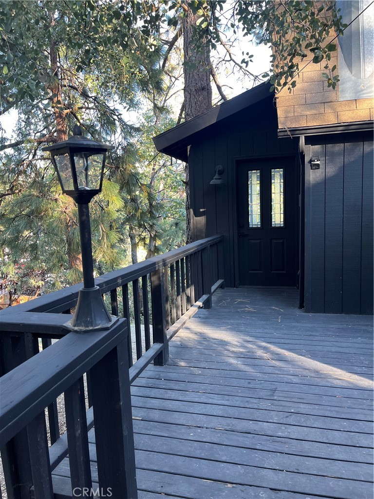 24875 Marion Ridge Drive Idyllwild, CA 92549 - Photo 7 of 47 a view of a porch with wooden floor and outdoor seating