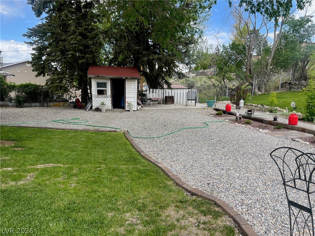 12 Reno Road Ely, NV 89301 - Photo 20 of 21 View of back yard featuring a storage unit
