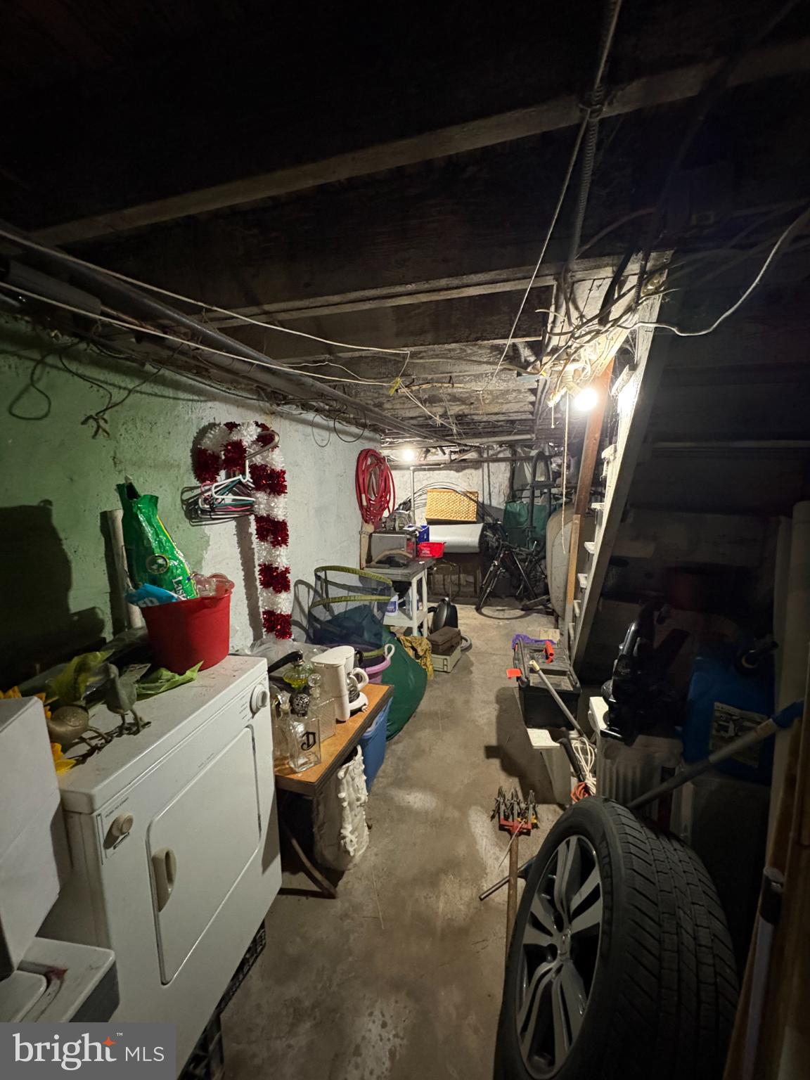 2419 Upland Street Chester, PA 19013 - Photo 25 of 27 Dimly lit basement with cluttered storage.