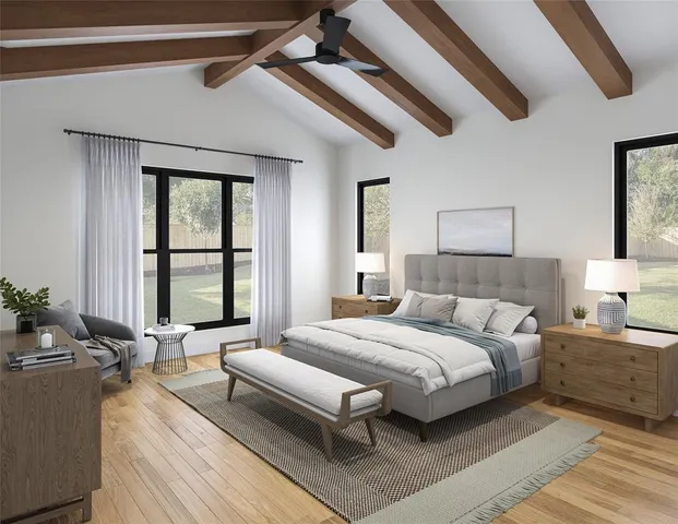 a bedroom with a large bed and windows