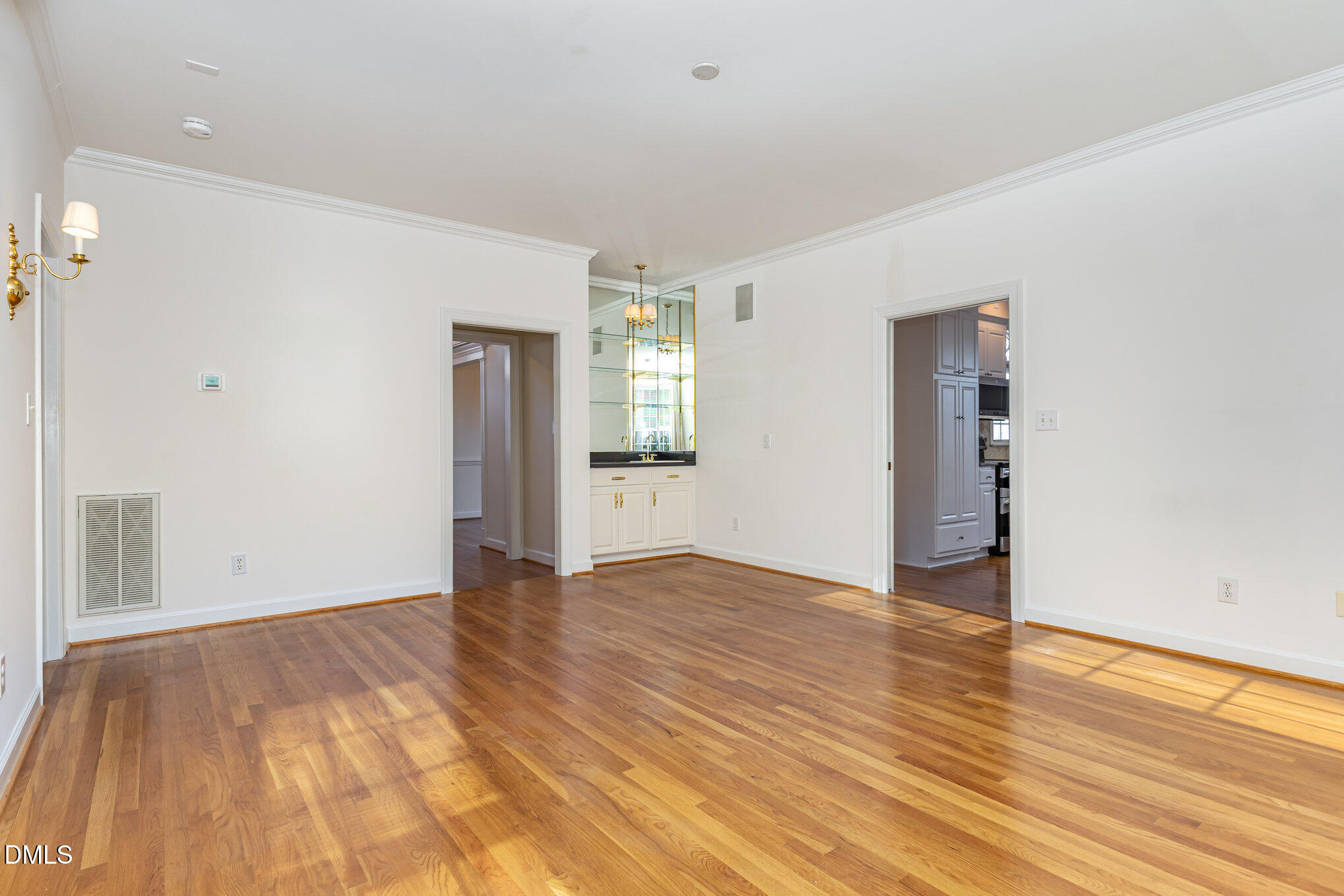 712 Hardimont Road Raleigh, NC 27609 - Photo 9 of 40 a view of an empty room with wooden floor and a window