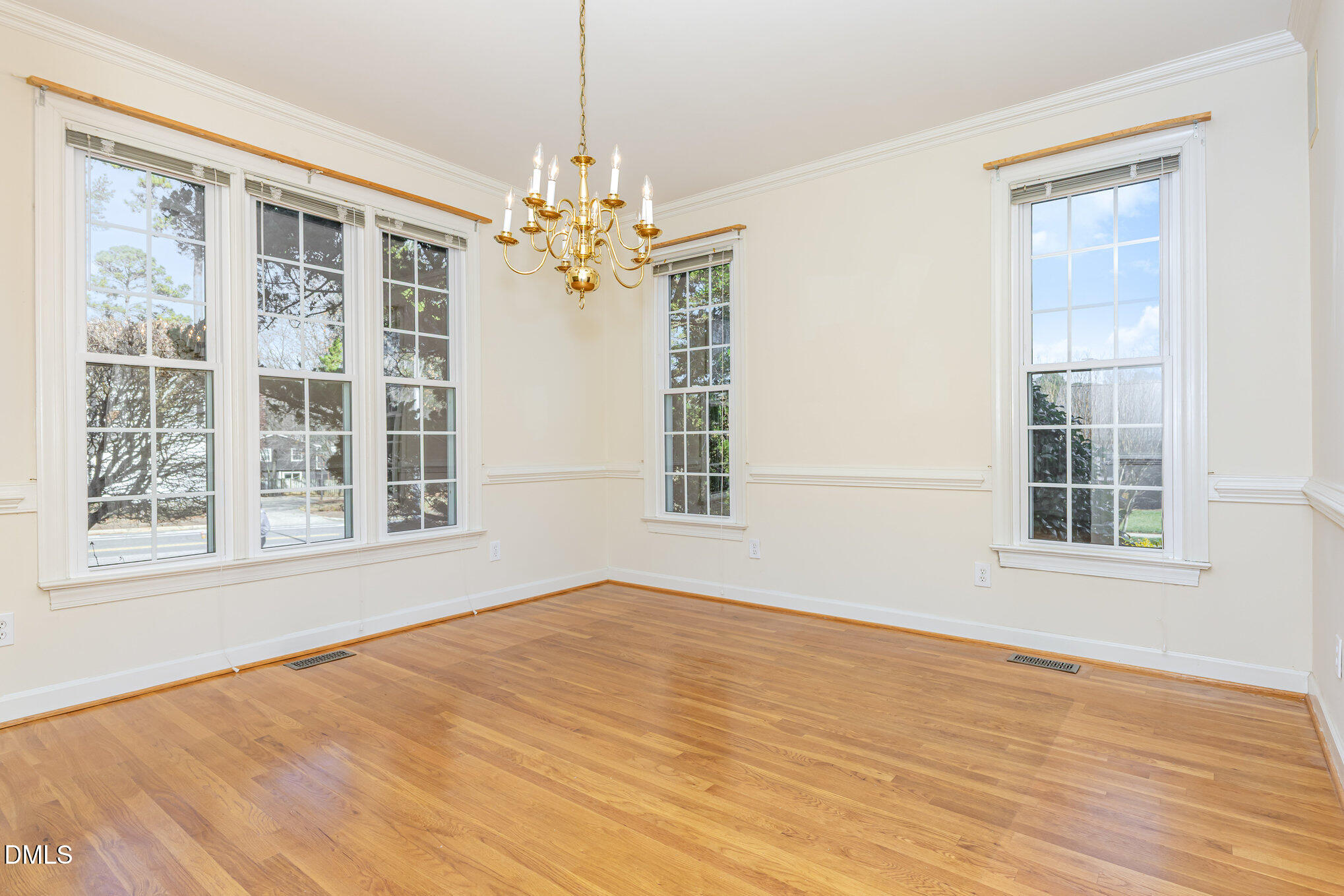 712 Hardimont Road Raleigh, NC 27609 - Photo 11 of 40 a view of an empty room with a window and wooden floor