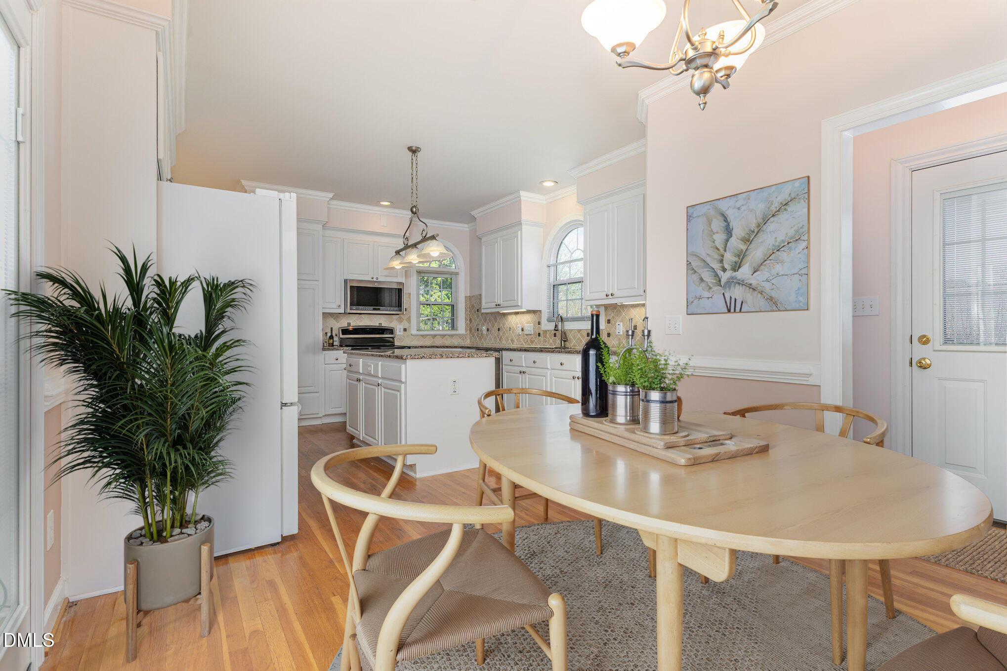 712 Hardimont Road Raleigh, NC 27609 - Photo 14 of 40 a dining room with furniture a potted plant and a kitchen view