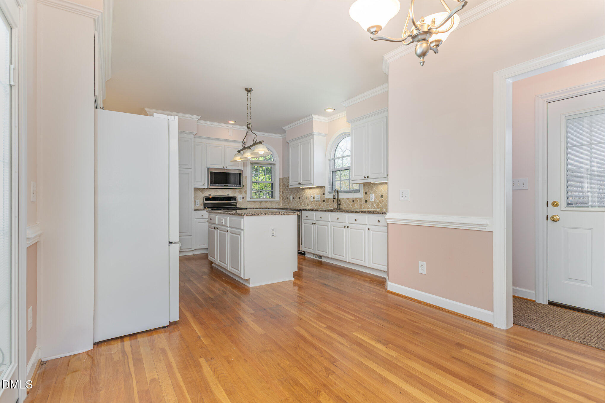 712 Hardimont Road Raleigh, NC 27609 - Photo 15 of 40 a kitchen with kitchen island white cabinets and stainless steel appliances