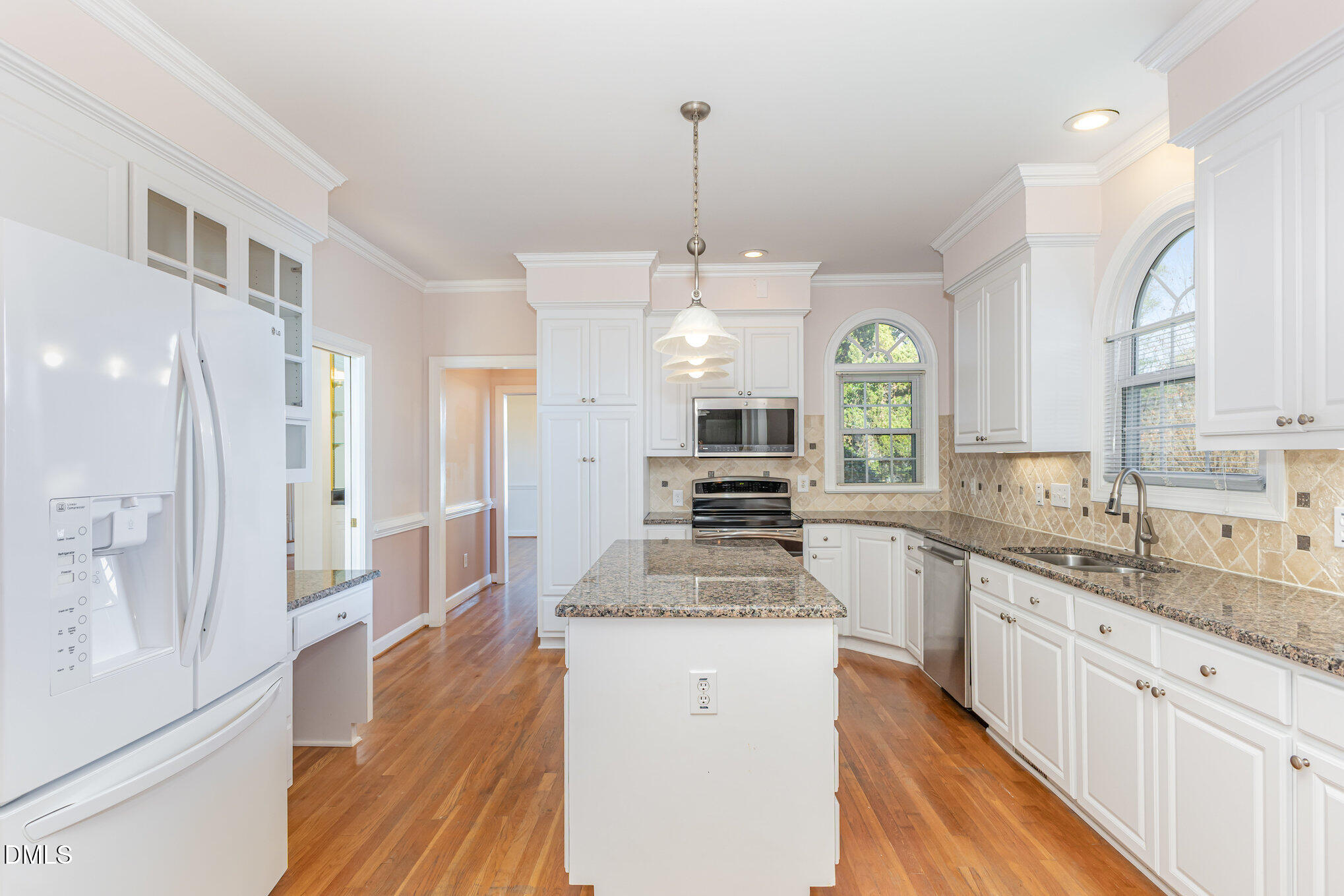 712 Hardimont Road Raleigh, NC 27609 - Photo 17 of 40 a large kitchen with granite countertop a large kitchen island white cabinetry and stainless steel appliances