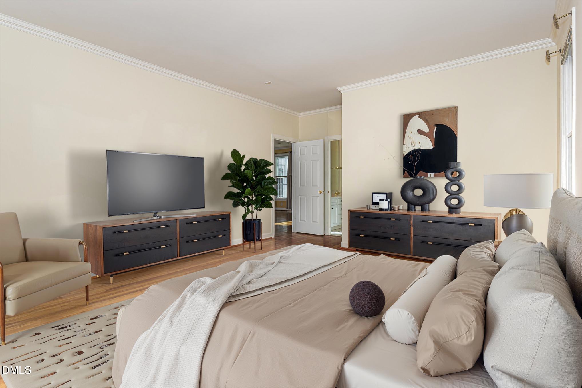 712 Hardimont Road Raleigh, NC 27609 - Photo 20 of 40 a bedroom with a bed and a flat screen tv