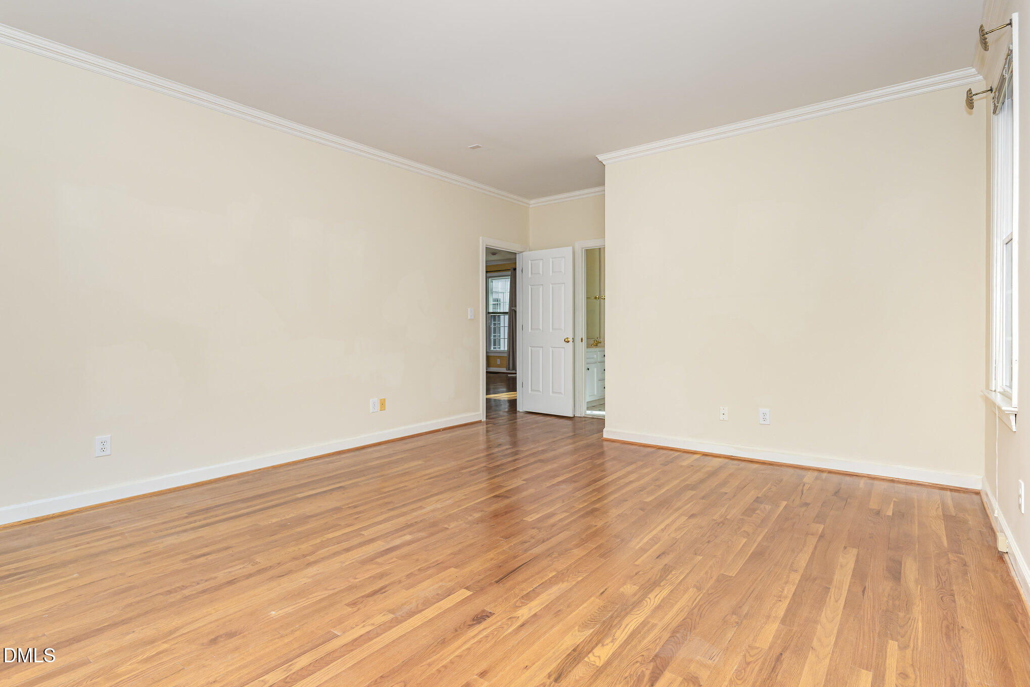 712 Hardimont Road Raleigh, NC 27609 - Photo 21 of 40 a view of an empty room with wooden floor and a window
