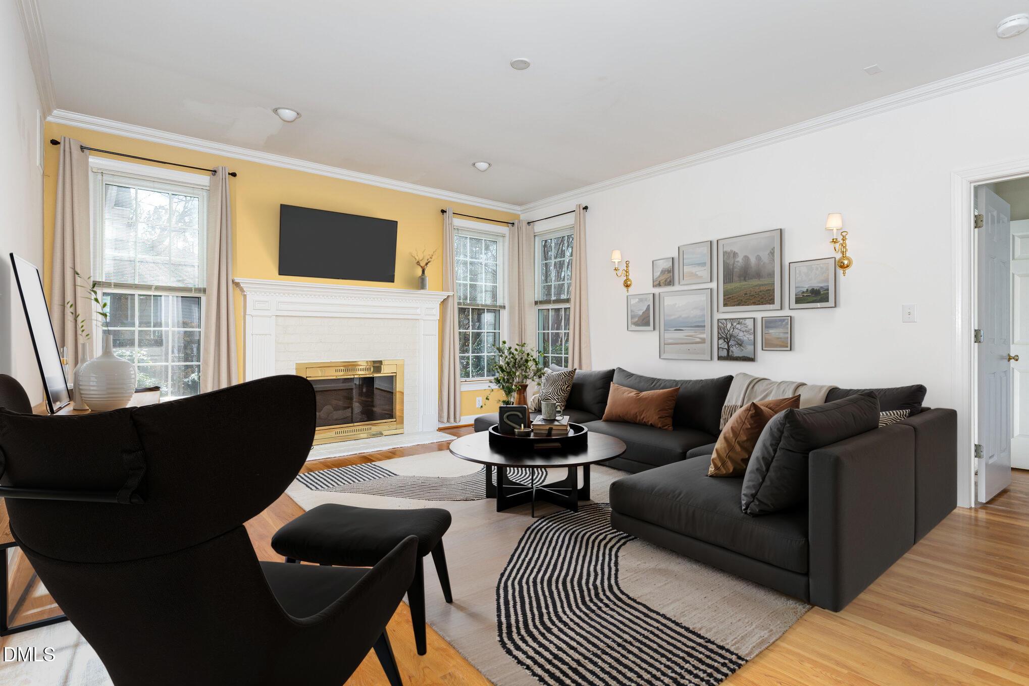712 Hardimont Road Raleigh, NC 27609 - Photo 6 of 40 a living room with furniture a fireplace and a flat screen tv