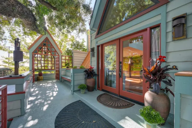 a dining room with furniture a rug and a floor to ceiling window