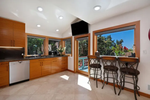 a kitchen with stainless steel appliances granite countertop a sink and a microwave