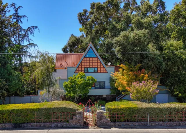 a backyard of a house with a yard and outdoor seating