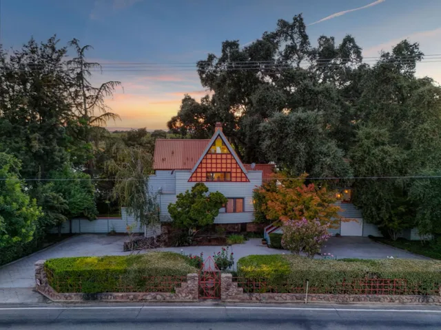 a view of a porch with chairs and potted plants
