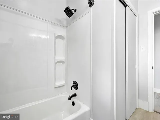 a bathroom with a bathtub and shower