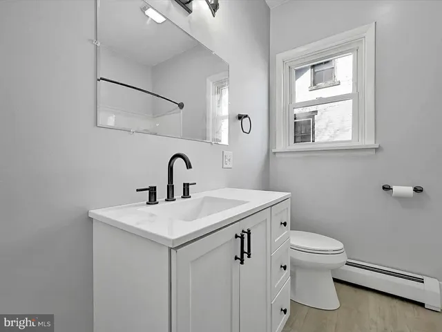 a bathroom with a toilet sink and mirror