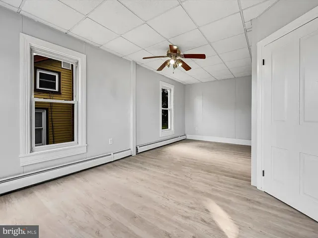 a view of room hardwood and ceiling fan