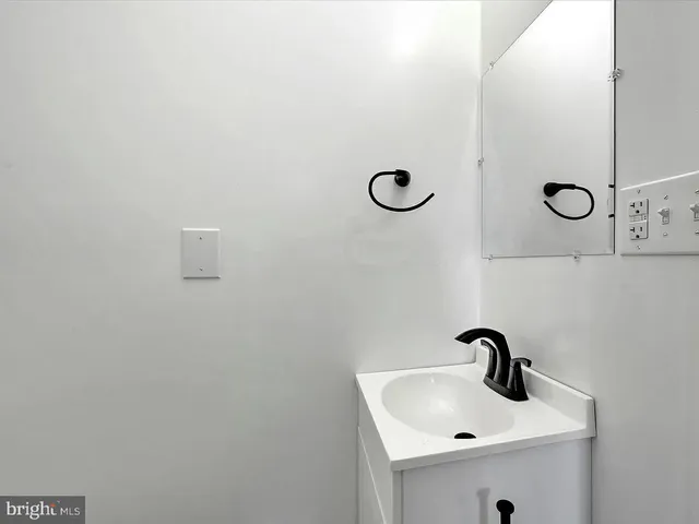 a bathroom with a sink and mirror