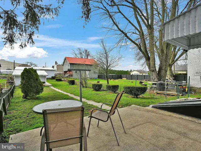 a view of a park with furniture and garden