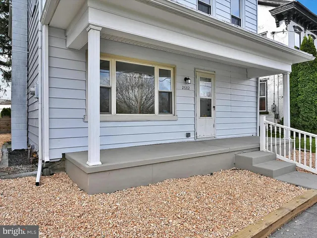 a view of a house with a small backyard