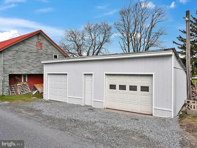 a view of a house with a yard and garage