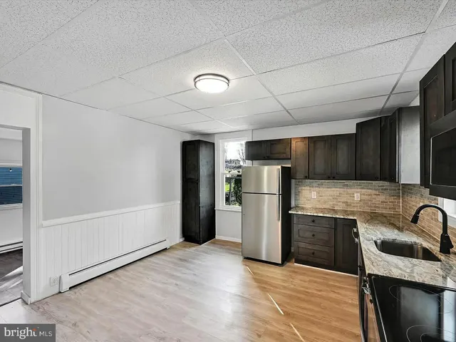 a kitchen with refrigerator and microwave
