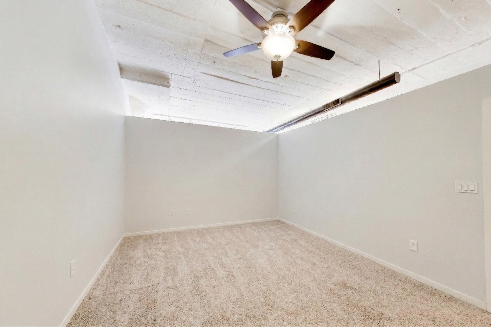 1069 West 14th Place, Unit 228 Chicago, IL 60608 - Photo 11 of 20 an empty room with a chandelier fan and ceiling fan