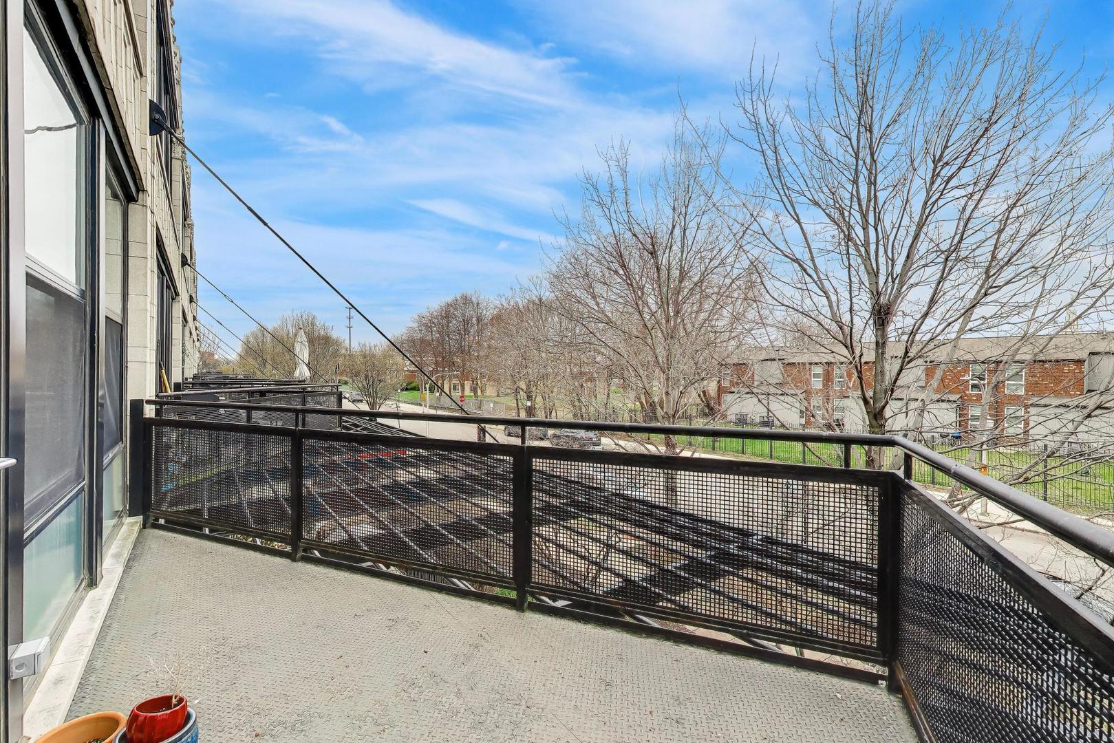 1069 West 14th Place, Unit 228 Chicago, IL 60608 - Photo 16 of 20 a view of balcony with wooden floor and fence