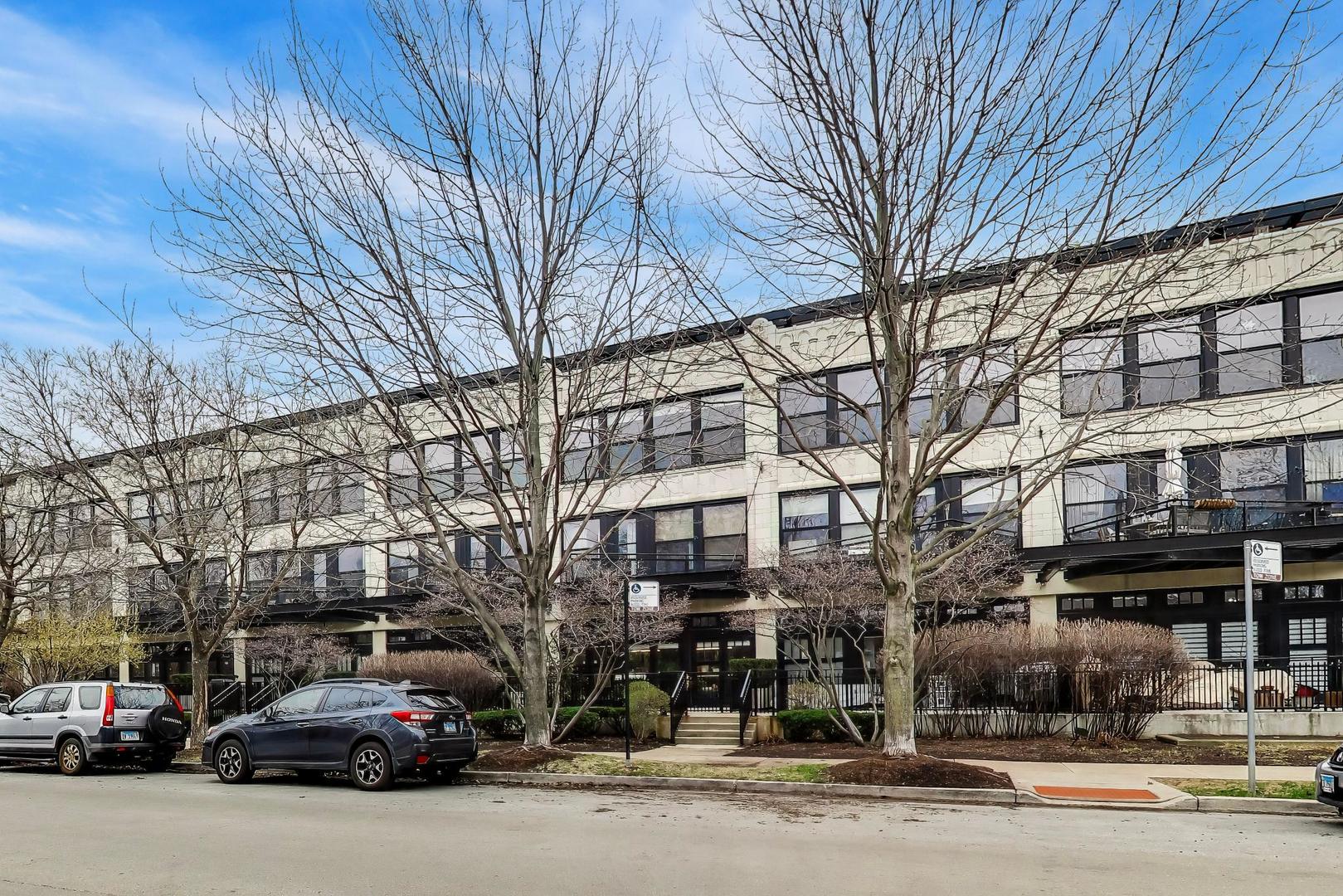 1069 West 14th Place, Unit 228 Chicago, IL 60608 - Photo 2 of 20 a building with trees in front of it