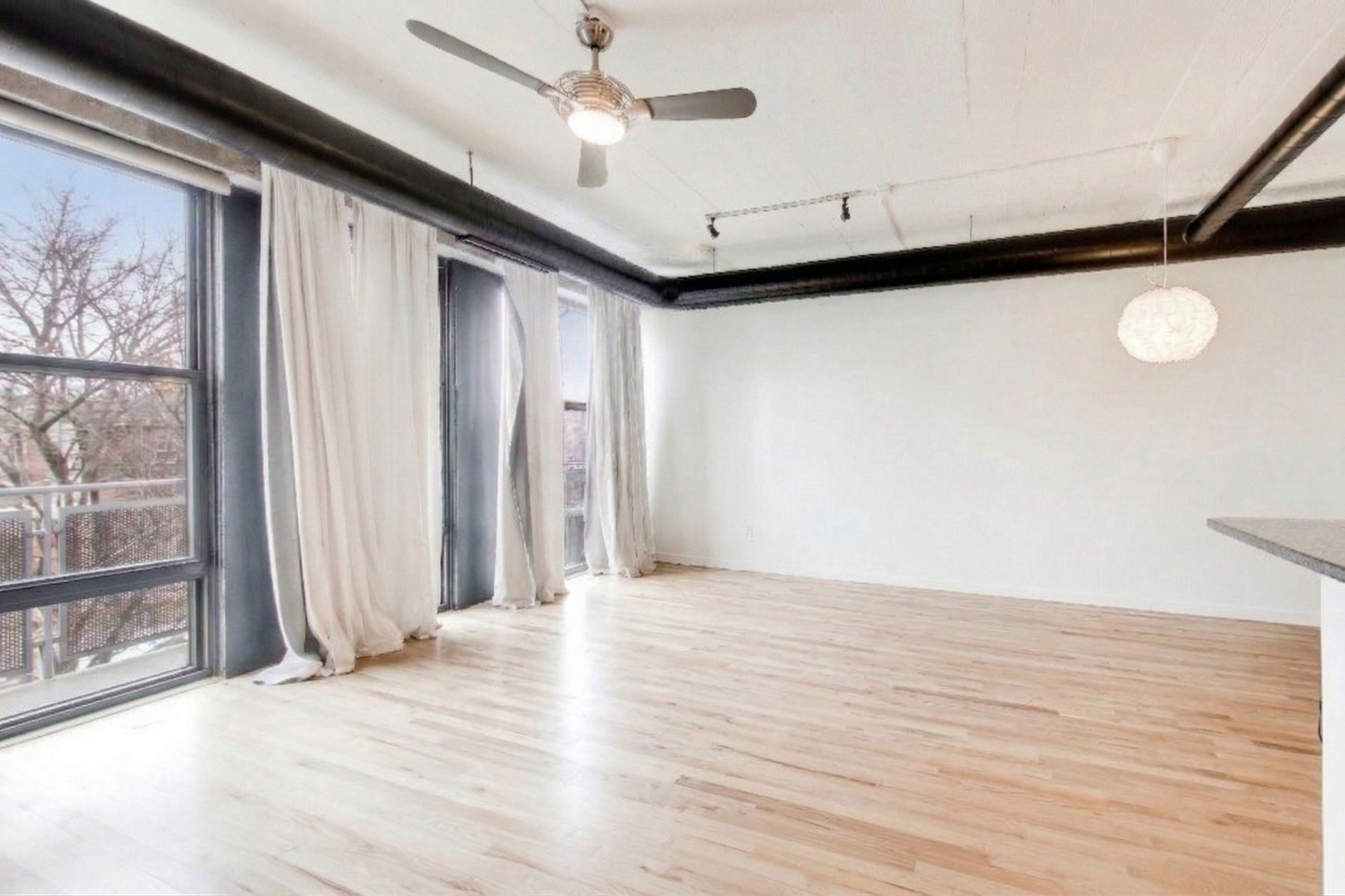 1069 West 14th Place, Unit 228 Chicago, IL 60608 - Photo 5 of 20 a view of an empty room with a window