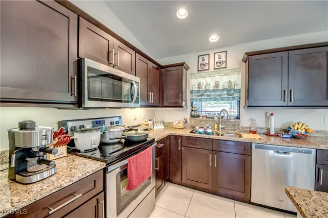 a kitchen with a sink stove top oven and cabinets