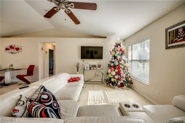 a bedroom with furniture and a flat screen tv