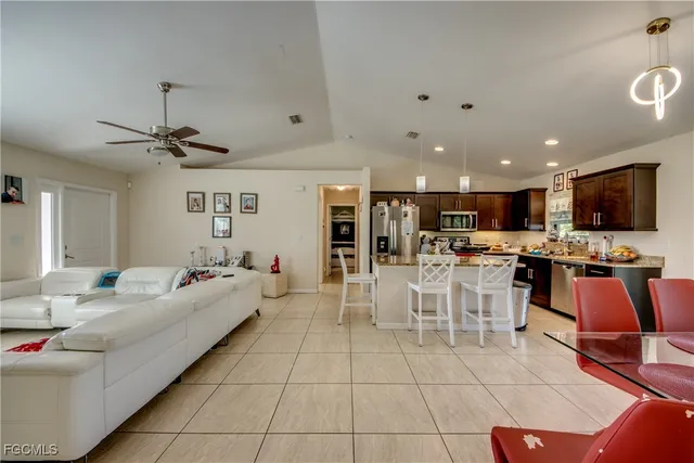a living room with lots of furniture and view of kitchen