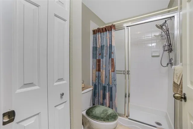 a dining room with furniture potted plants and wooden floor