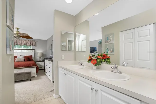 a living room with patio furniture and a potted plant