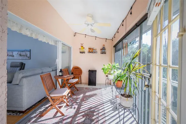 a view of a patio with table and chairs and potted plants