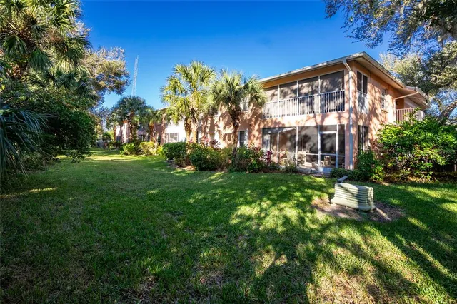 a view of a house with garden and sitting area