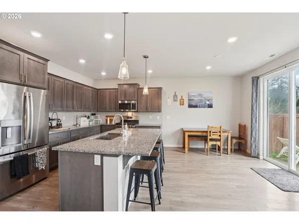 a kitchen with cabinets and wooden floor