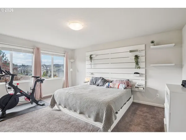 a bedroom with a bed a table and chairs